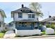 Charming two-story home featuring a covered porch and a well-maintained front yard at 3516 N Capitol Ave, Indianapolis, IN 46208