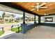 Inviting front porch with wood plank ceiling, fan, and dark trimwork, perfect for relaxing outdoors at 3516 N Capitol Ave, Indianapolis, IN 46208