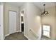 Hallway featuring a closet, modern light fixture, and view of the bathroom at 3516 N Capitol Ave, Indianapolis, IN 46208