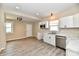 This modern kitchen boasts white cabinets, stainless steel appliances, and laminate flooring at 3516 N Capitol Ave, Indianapolis, IN 46208