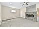 Bright living room with neutral walls, plush carpet, and striking stone fireplace at 3516 N Capitol Ave, Indianapolis, IN 46208