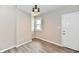 Room with a window, door, luxury vinyl plank flooring and modern lighting at 3516 N Capitol Ave, Indianapolis, IN 46208