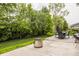Lush backyard featuring a patio with outdoor furniture, a grill, and mature trees for privacy at 3640 Snowdon Dr, Westfield, IN 46074