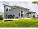 Green backyard showing blue home, patio set, grills, and covered hot tub at 3640 Snowdon Dr, Westfield, IN 46074