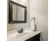 Cozy bathroom featuring a black framed mirror, black fixtures, and a sleek countertop at 3640 Snowdon Dr, Westfield, IN 46074
