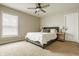 Bright bedroom with neutral tones, featuring a bed, bedside tables, and a window for natural light at 3640 Snowdon Dr, Westfield, IN 46074