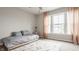 Bright bedroom with a large window, simple bed, and light-colored curtains, offering a peaceful atmosphere at 3640 Snowdon Dr, Westfield, IN 46074