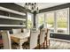 Elegant dining area with large windows and stylish decor, perfect for hosting gatherings and enjoying meals at 3640 Snowdon Dr, Westfield, IN 46074