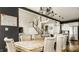 Beautiful dining room featuring a rustic table, upholstered chairs, and modern lighting fixtures at 3640 Snowdon Dr, Westfield, IN 46074