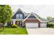 Charming two-story home featuring a brick and blue facade, complemented by a well-manicured lawn at 3640 Snowdon Dr, Westfield, IN 46074