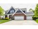 Charming two-story home featuring a brick and blue facade, complemented by a well-manicured lawn at 3640 Snowdon Dr, Westfield, IN 46074