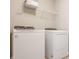 Functional laundry room equipped with a Whirlpool washer, dryer, and shelving for storage at 3640 Snowdon Dr, Westfield, IN 46074