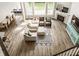 Aerial view showcasing the living room with its stylish furniture, fireplace, and abundant natural light at 3640 Snowdon Dr, Westfield, IN 46074