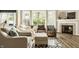 Inviting living room featuring a cozy fireplace, comfortable seating, and large windows offering ample natural light at 3640 Snowdon Dr, Westfield, IN 46074