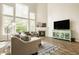 Bright living room featuring soaring ceilings, large windows, and a cozy fireplace with decorative accents at 3640 Snowdon Dr, Westfield, IN 46074