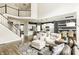 Open-concept living room with soaring windows, hardwood floors, and a seamless flow to the kitchen at 3640 Snowdon Dr, Westfield, IN 46074