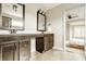 Bathroom with double vanity sinks, dark wood cabinetry and framed mirrors, featuring tile floors at 3640 Snowdon Dr, Westfield, IN 46074