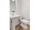 Bathroom with a pedestal sink, modern fixtures, white toilet, and wood-look vinyl flooring at 3737 Planck St, Danville, IN 46122