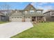 Charming two-story home with a well-manicured lawn, three-car garage, and inviting curb appeal at 3737 Planck St, Danville, IN 46122
