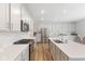 Well-lit kitchen featuring white cabinets, stainless steel appliances, and hardwood floors at 3737 Planck St, Danville, IN 46122