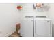 Laundry room with side-by-side washer and dryer, storage shelving, and vinyl flooring at 3737 Planck St, Danville, IN 46122