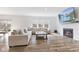 Bright living room with hardwood floors, a fireplace, large windows, and cozy sectional seating at 3737 Planck St, Danville, IN 46122