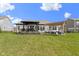 Spacious backyard featuring a covered patio, pergola seating area and lush green lawn at 3840 Shady Lake Dr, Westfield, IN 46074