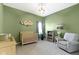 Charming Bedroom with a crib, glider, and soft green walls at 3840 Shady Lake Dr, Westfield, IN 46074