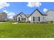 Beautiful single-Gathering home with a white brick exterior, dark shutters, a gray roof and a perfectly manicured front lawn at 3840 Shady Lake Dr, Westfield, IN 46074
