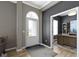 Inviting foyer with a transom window above the front door, gray walls, light wood floors and an office to the side at 3840 Shady Lake Dr, Westfield, IN 46074