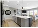 Open kitchen with a large island, stainless steel appliances, and views into the living area at 3840 Shady Lake Dr, Westfield, IN 46074