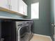 Functional laundry room with modern washer, dryer, and cabinetry at 3840 Shady Lake Dr, Westfield, IN 46074