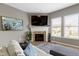 Comfortable living room offers a fireplace, TV, and a view of the backyard through bright windows at 3840 Shady Lake Dr, Westfield, IN 46074