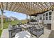 Inviting patio features comfortable seating around a stone fire pit and stylish pergola at 3840 Shady Lake Dr, Westfield, IN 46074
