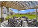 Relaxing patio with comfortable seating, a fire pit, and beautiful pergola in a large backyard at 3840 Shady Lake Dr, Westfield, IN 46074