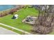 Community playground area with play equipment near a green lawn and serene pond at 3840 Shady Lake Dr, Westfield, IN 46074