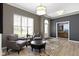Cozy sitting room with neutral paint, light wood floors, two arm chairs, an ottoman and views of the front yard at 3840 Shady Lake Dr, Westfield, IN 46074