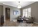 Cozy sitting room with neutral paint, light wood floors, two arm chairs, an ottoman and plenty of natural light at 3840 Shady Lake Dr, Westfield, IN 46074