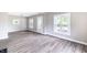 Light-filled living room boasting updated floors, neutral walls, and large windows at 3902 N Capitol Ave, Indianapolis, IN 46208
