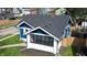 A high-angle view reveals a charming blue home with a well maintained dark roof at 3967 N Park Ave, Indianapolis, IN 46205