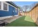 A fenced backyard with artificial grass and a well-maintained exterior at 3967 N Park Ave, Indianapolis, IN 46205