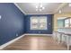 Bright dining area with modern chandelier, bar seating, and light vinyl flooring at 3967 N Park Ave, Indianapolis, IN 46205