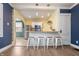 Open kitchen area with stainless steel appliances, breakfast bar, and bright, natural light at 3967 N Park Ave, Indianapolis, IN 46205
