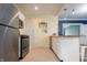 Galley kitchen features stainless steel appliances and white cabinets at 3967 N Park Ave, Indianapolis, IN 46205