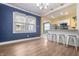Open living area with hardwood floors and kitchen breakfast bar at 3967 N Park Ave, Indianapolis, IN 46205