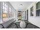 Bright sunroom with multiple windows, white brick accents, and charming decorative vase at 3967 N Park Ave, Indianapolis, IN 46205