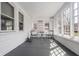 Bright sunroom with large windows, charming seating, and a patterned rug at 3967 N Park Ave, Indianapolis, IN 46205
