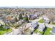 An aerial view showcases a neighborhood with mature trees, local buildings, and clear roads at 401 N Swope St, Greenfield, IN 46140
