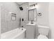 This modern bathroom features sleek gray tile, a stylish vanity, and a relaxing bathtub at 401 N Swope St, Greenfield, IN 46140