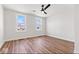 This spacious bedroom features hardwood floors, a ceiling fan, and plenty of natural light at 401 N Swope St, Greenfield, IN 46140